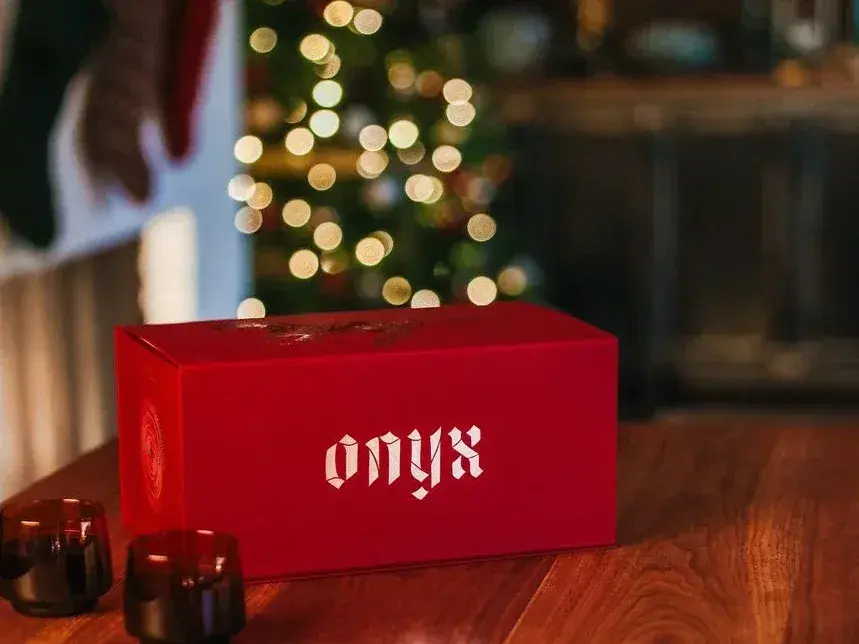 Red Onyx Coffee Lab advent calendar box on a table in front of a Christmas tree